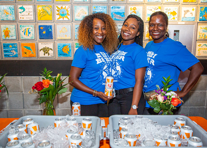 three women volunteering at event