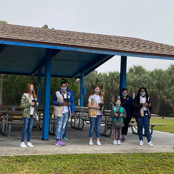 girl scouts holding mangrove plants