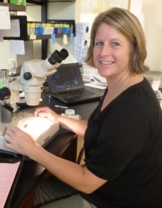 Dr. Heather Judkins with microscope