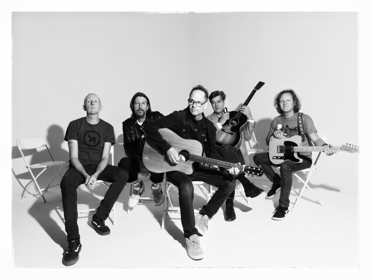 men sitting down holding musical instruments