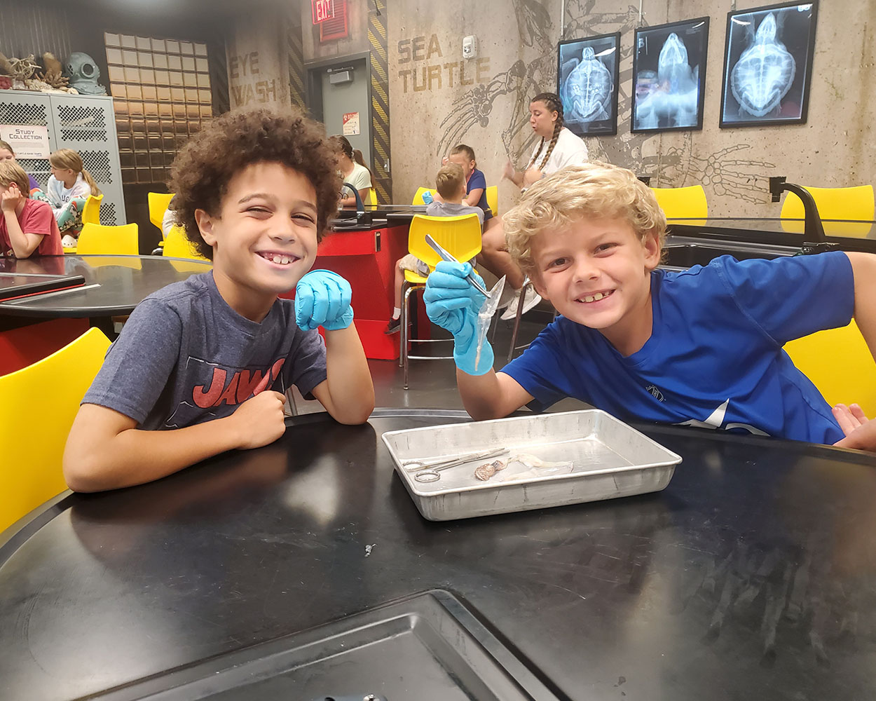 kids at camp posing with dissection materials