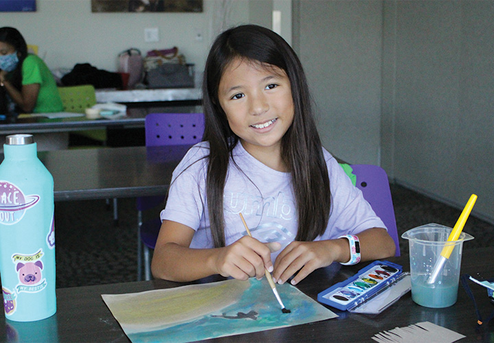 young_girl_painting_at_table