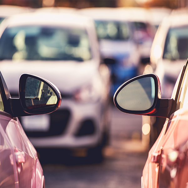 two cars parked side by side in parking lot