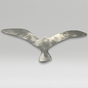 Metal sculpture of a large size bird on a gray background