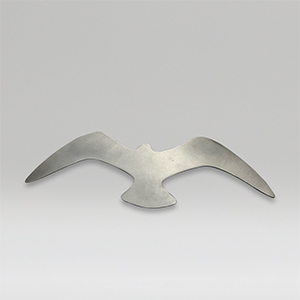 Metal sculpture of a medium size bird on a gray background