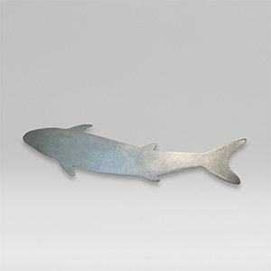 Metal sculpture of a medium size fish on a gray background