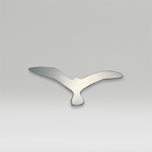 Metal sculpture of a small size bird on a gray background