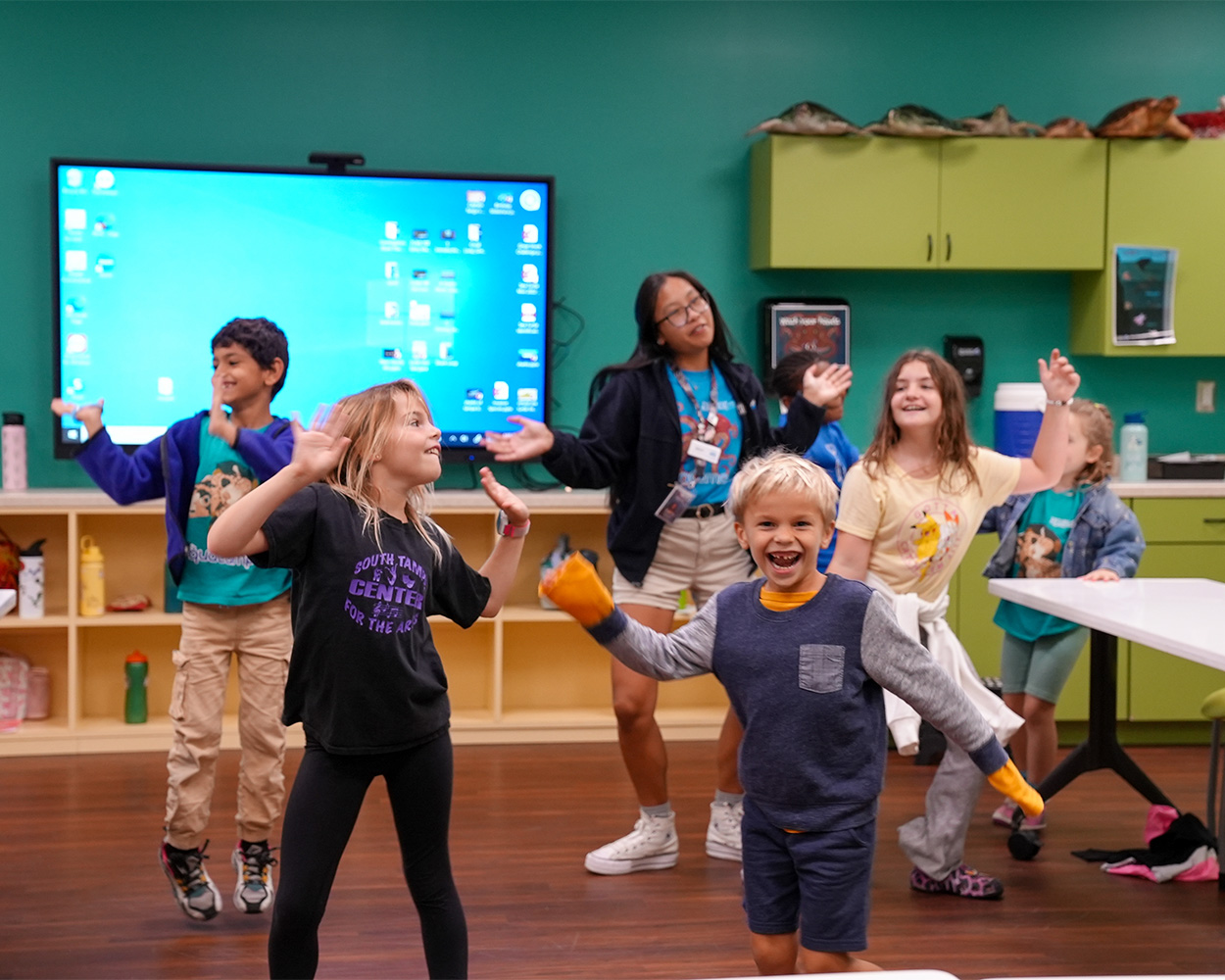 group of kids dancing with a camp staffer