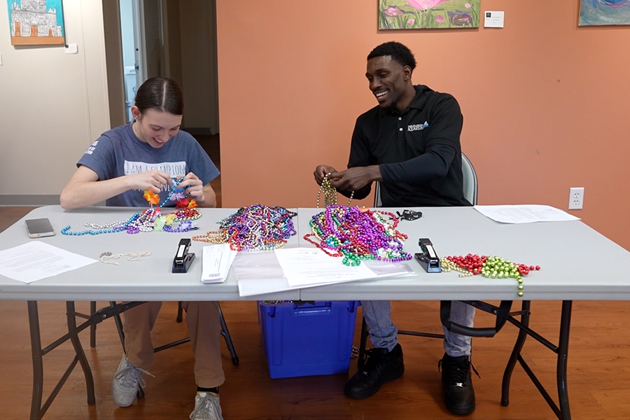 Two employees from The Florida Aquarium sorting beads