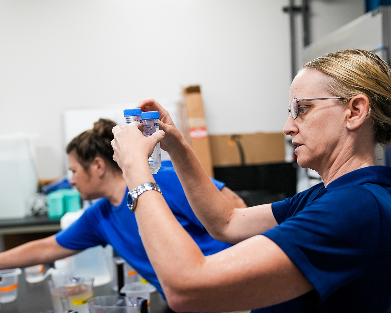 keri o'neil holding test tubes in research lab