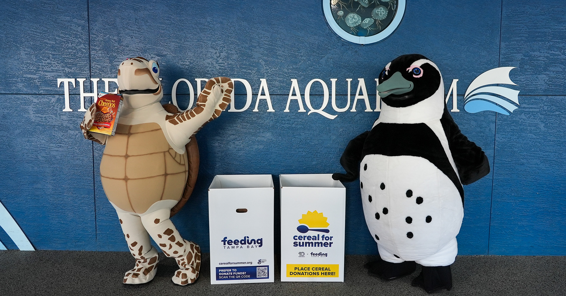 Rocky and Tango donating to the Cereal for Summer boxes at the Florida Aquarium
