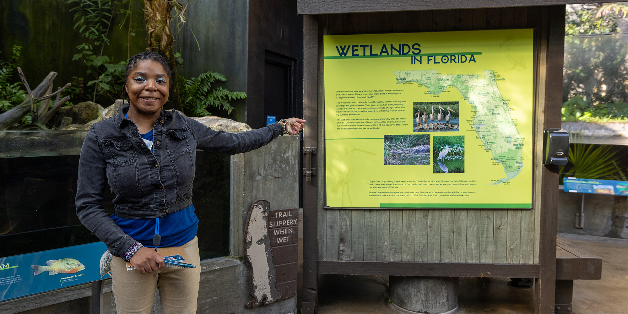 Volunteer at the Florida Aquarium directing people through the walk path.