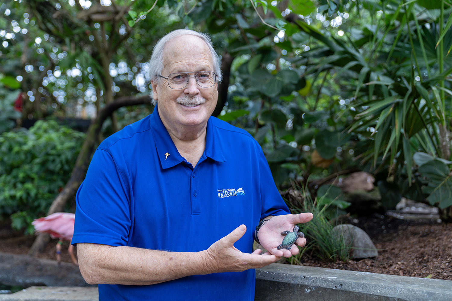 Ken-Moser-holding-handcrafted-sea-turtle-in-Wetlands at The Florida Aquarium