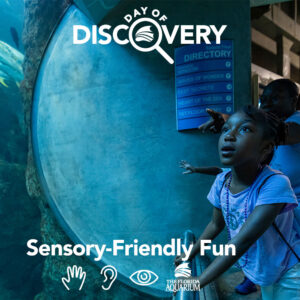 Young girl looking in awe at animals in coral tunnel with her mom during Day of Discovery at The Florida Aquarium