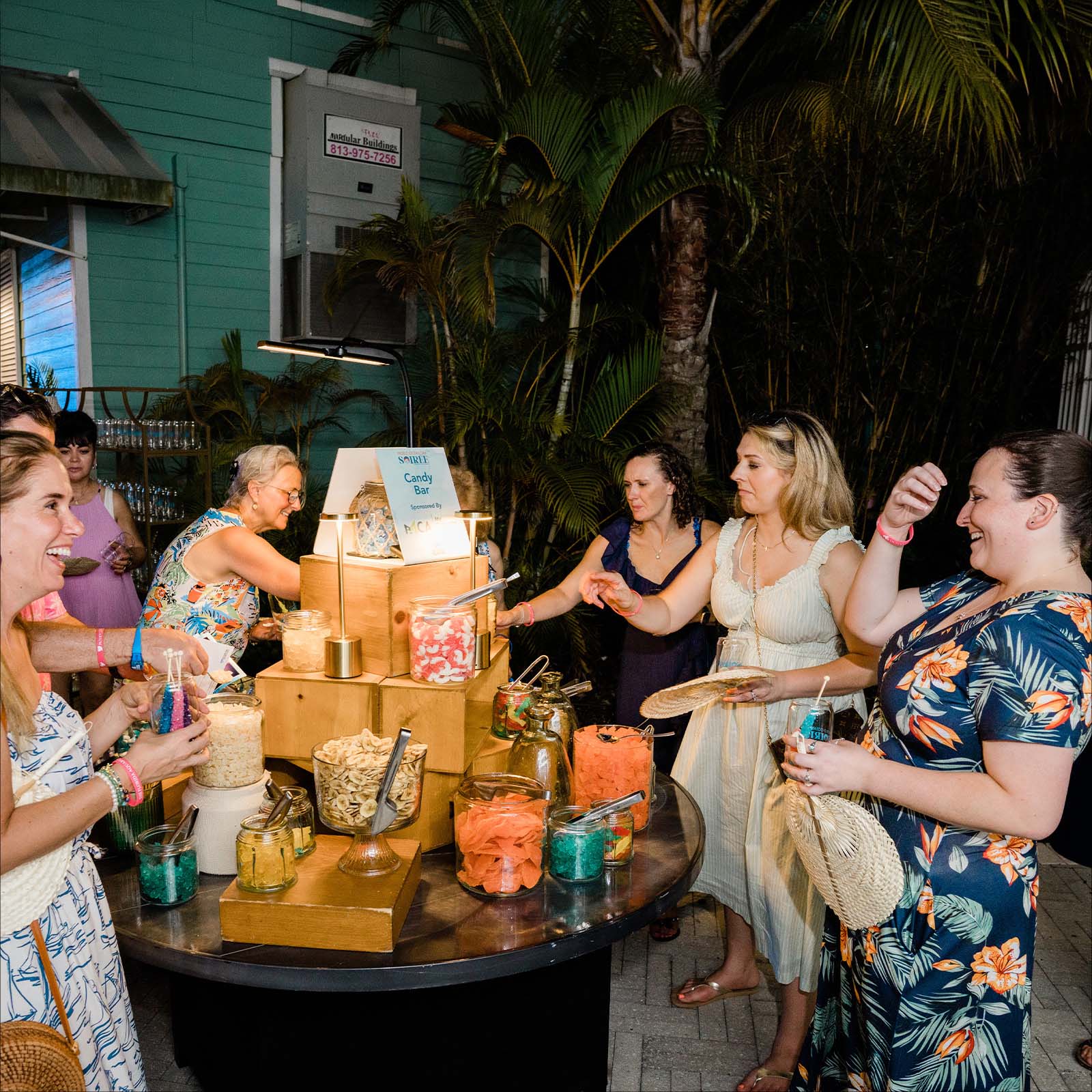 group of women having fun and laughing at the candy bar
