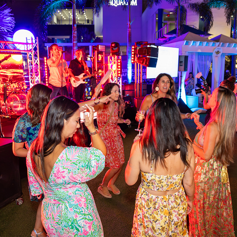 A group of female friends dancing at night