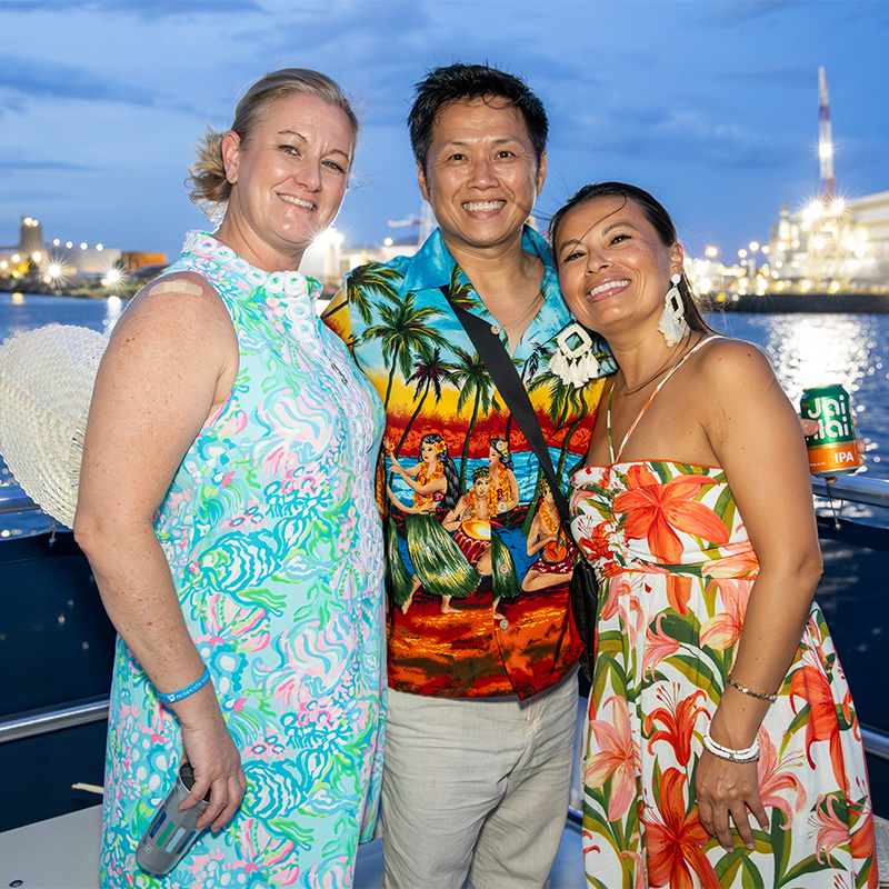 Friends posing for a picture on the World Ocean Day Soiree sunset cruise