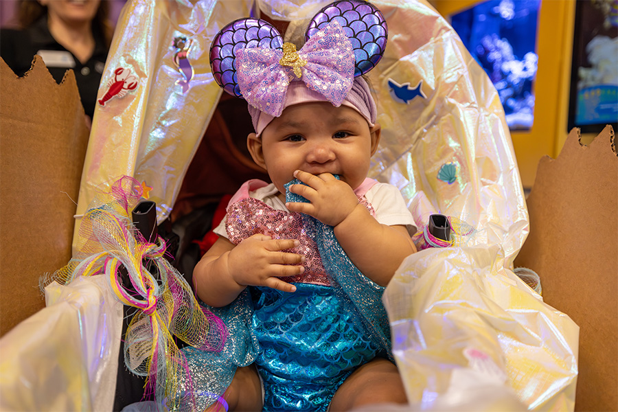 Baby girl dressed as mermaid Minnie Mouse for Guppyween event at The Florida Aquarium